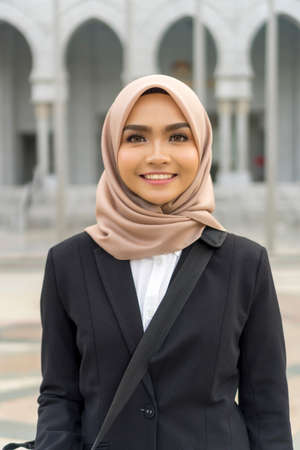 Portrait of Cute Malay Woman wearing hijab outdoor and smileの写真素材