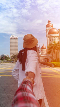 Travel Concept, Muslim Tourist Couple at Kuala Lumpur follow me hand pullingの写真素材