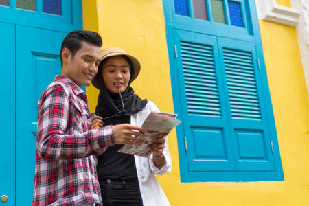 Travel Concept, Muslim Tourist Couple at Kuala Lumpur discussing as they were lostの写真素材
