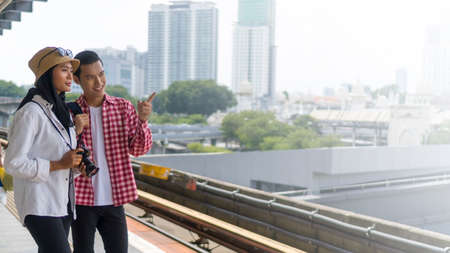 Travel Concept, Muslim Tourist couple at the train station