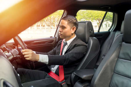 E-Hailing Concept, young asian man driving a car wearing seatbelt