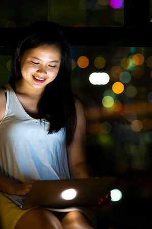Lifestyle concept, Beautiful young Asian girl working with a laptop connecting to internet via...