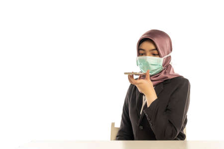 Business Lifestyle, Cute Malay Woman wearing hijab talking to the phone loudspeaker