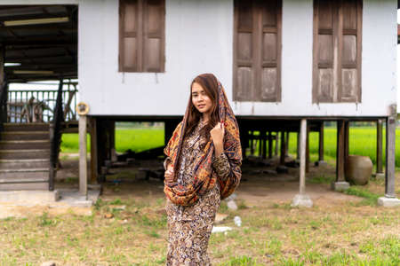 Asian Malay lady wearing traditional cloth outdoor at the old abandon houseの写真素材