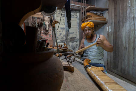 Local demonstrate on making art of crafting Malay Traditional asymmetrical Dagger called "Keris"の写真素材