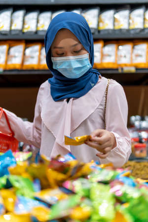 New Normal Concept, Cute Malay Girl at bench with no sitting marking for social distancing