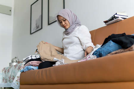 Lifestyle at home, cute malay woman at the sofa reading booksの写真素材