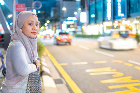Online Dating Concept, Beautiful Malay girl outdoor using smartphone