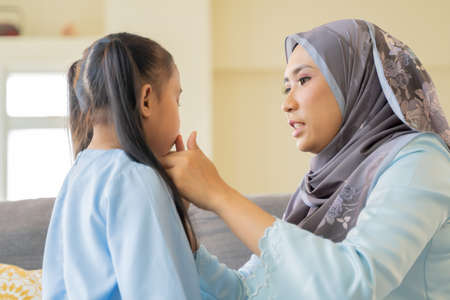 Eid Mubarak aidilfitri celebration moment, kiss and shaking hands symbol of forgivingの写真素材