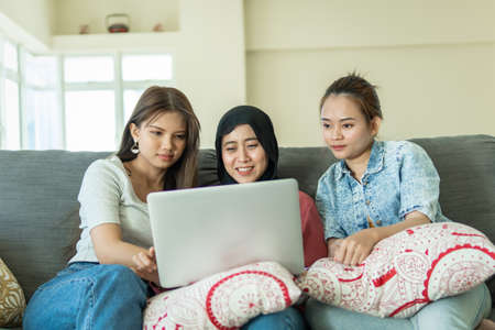 Urban lifestyle concept, Urban lifestyle concept, 3 asian lady at the sofa using laptopの写真素材