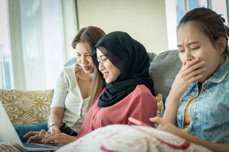 Urban lifestyle concept, Urban lifestyle concept, 3 asian lady at the sofa using laptopの写真素材