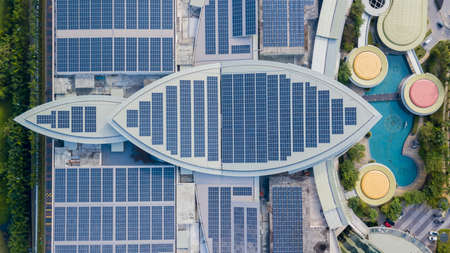 Solar panel on top of high commercial building. Solar Panel uses photo-voltaic cells use sunlight as...
