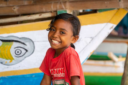 LAMALERA, NUSA TENGGARA, INDONESIA - DEC 13, 2018: Portrait of little little girl smiling at Lamalera Indonesiaのeditorial素材