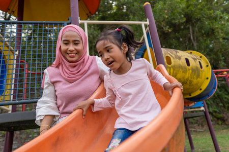 Family moment young mother with daughter at the parkの写真素材