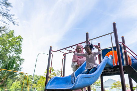 Family moment young mother with daughter at the parkの写真素材
