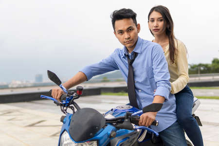 Relationship moment young couple on a bikeの写真素材