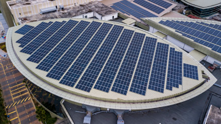 Aerial view of a solar panel photovoltaic with reflection on building roof top. Part of reduce reuse and restore, Renewable energy conceptの写真素材
