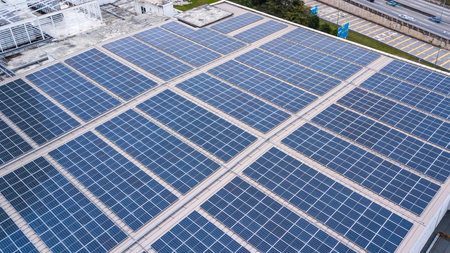Aerial view of a solar panel photovoltaic with reflection on building roof top. Part of reduce reuse...