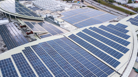 Aerial view of a solar panel photovoltaic with reflection on building roof top. Part of reduce reuse...