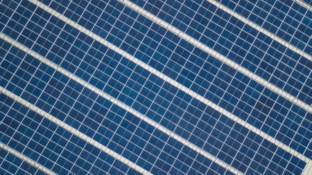 Aerial view of a solar panel photovoltaic with reflection on building roof top. Part of reduce reuse...