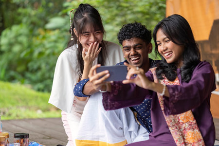 Group of Malaysian student wearing traditional cloth for festival celebration focusing on middle personの写真素材