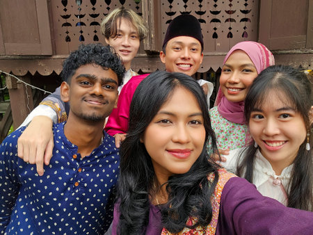 A group of malay people at the wooden house celebrating Hari Raya festiveの写真素材