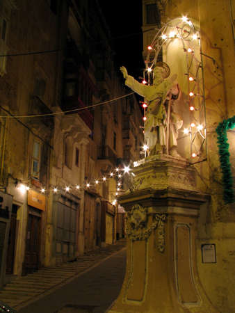A stone statue of Saint Paul in a street in Valletta, Malta.の写真素材