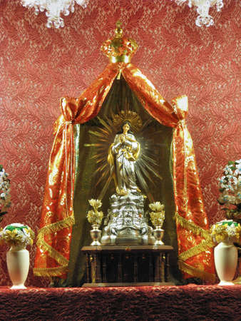 A miniature statue of The Immaculate Conception on display in a window in a street in Cospicua, Malta の写真素材