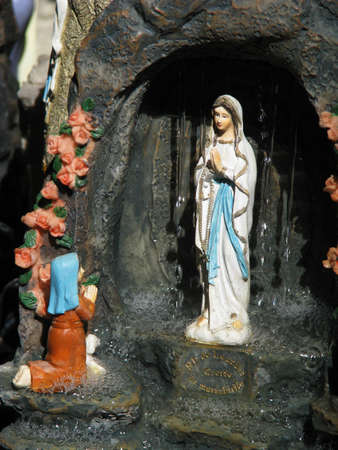A souvenir of Our Lady of Lourdes on sale in a souvenir shop at Lourdes, France.