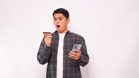 Asian young man with Shock expression while pay credit card bills