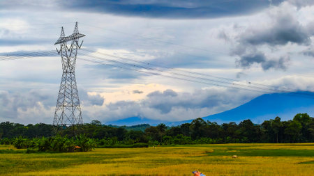 electric tower with mountain background with very dramatic cloudsの写真素材