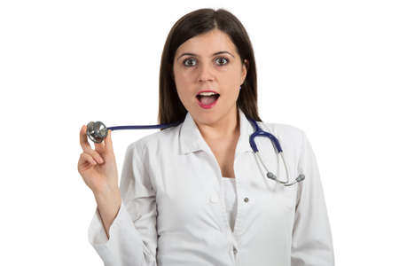 Closeup portrait of friendly, smiling confident female doctor holding stethoscope, healthcare professional isolated on white background.の写真素材