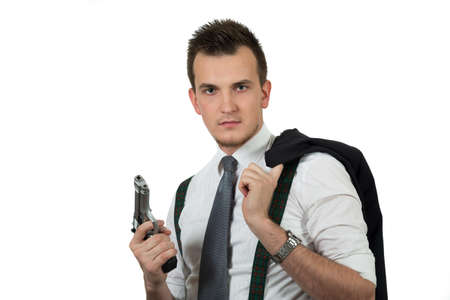 Young man pointing a gun isolated on white backgroundの写真素材