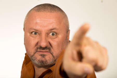 An angry man with beard pointing finger at you
