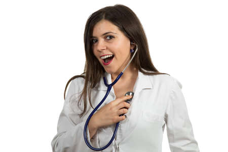 Closeup portrait of friendly, smiling confident female doctor holding stethoscope, healthcare professional isolated on white background.の写真素材
