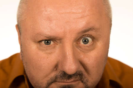 Man with big eyes staring at you over white background