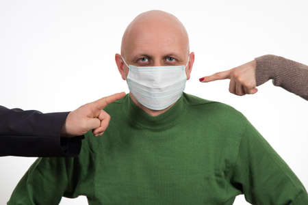 Two fingers pointing at Flu illness young man in medicine healthcare mask