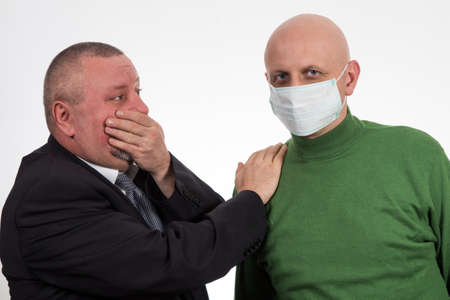 Businessman comforting young man suffering from cancer
