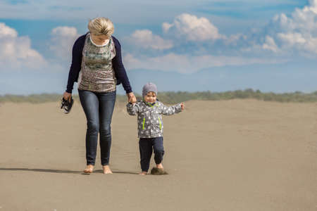 Mother and kid on the beach, happy mothers day.の写真素材