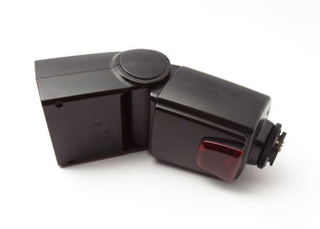A flashgun for DSLR camera over white backgroundの写真素材