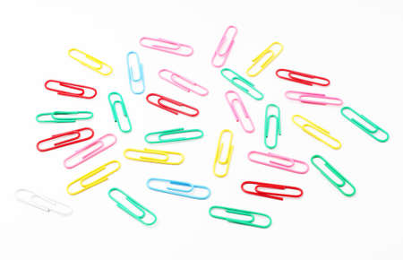 Colorful paper clips scattered on white backgroundの写真素材