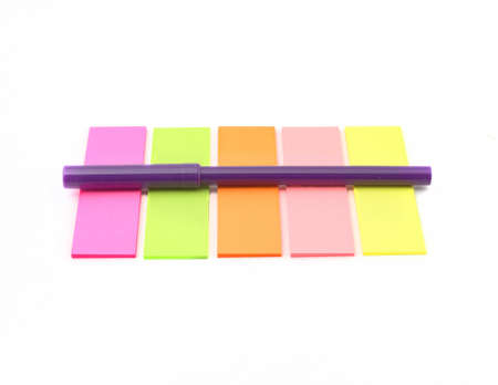 Sticky notes and a pen isolated on white