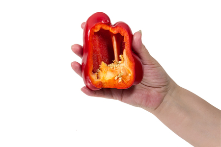 Senior woman's hand Keeps the cut red pepper isolated on white backgroundの写真素材