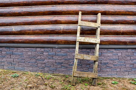 Neutral background wall of round logs of ropes and a lading textured staircaseの写真素材