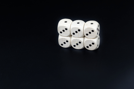 Worn white dices on a black matte backgroundの写真素材