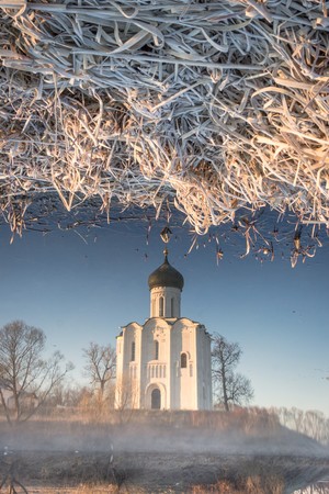 Reflection of the traditional Russian church in the Gulf of the Nerl River in the early autumn morningの写真素材