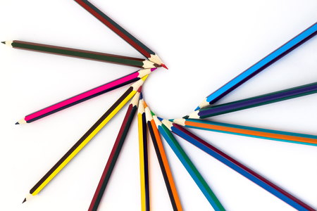 Colored pencils isolated on a white background, laid out by a fanの写真素材