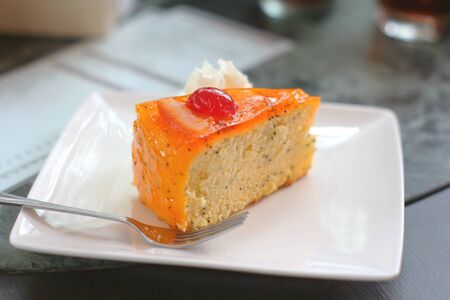 yummy carrot cake with cherry and whip cream の写真素材
