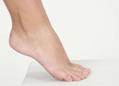 Woman s Bare Feet Against a White Studio Background