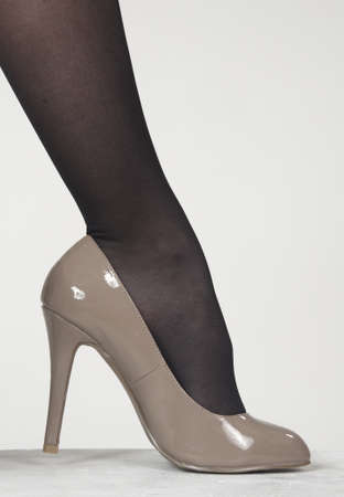Close up of woman s high heel shoes against a white studio backgroundの写真素材